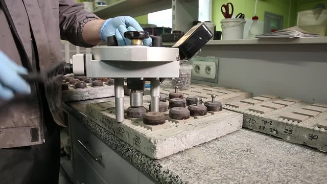 Testing of polymer glue for ceramic tiles. Laboratory tests in production of cement and concrete. Test samples of tile adhesive for strength in laboratory of plant before producing a large batch.