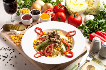 Fresh salad with chicken breast, arugula and tomato.