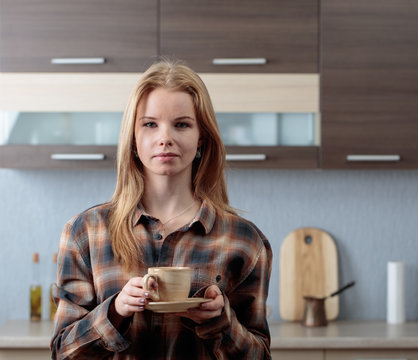  Young  woman with coffee mug .