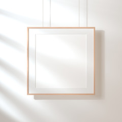 Square poster with wooden frame mockup hanging on the wall with shadows, 3d 