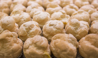 pastries, bignè with crea and icing sugar
