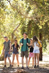 Smiling friends standing on field