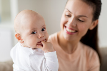 happy mother with little baby boy at home