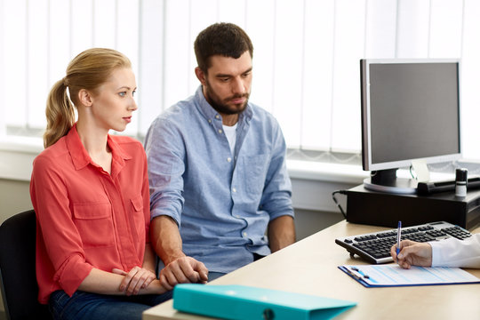 Couple Visiting Doctor At Family Planning Clinic