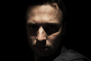 Obraz premium Portrait of young European man over black