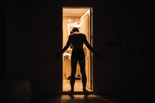 Young Adult Sad Man Stands In Open Door