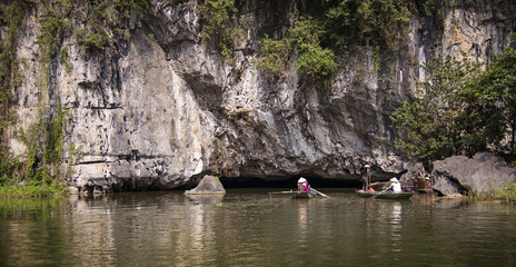 The boat is next to the rock. Ninh Binh Province, Ha Long Bay on land, Vietnam