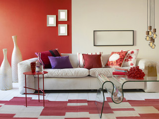 red wall living and dining room concept with coffee table and white sofa