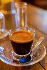 espresso coffee in transparent cup on a wooden table