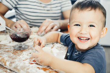 Fototapeta premium Detail of hands kneading dough