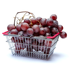 Grapes in shopping cart isolated on white