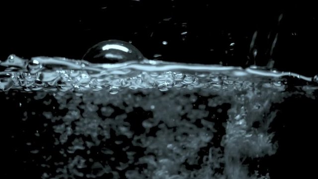Bubbles on black background. boiling water close up