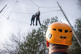 men at adventure climbing park walks by a rope simulator