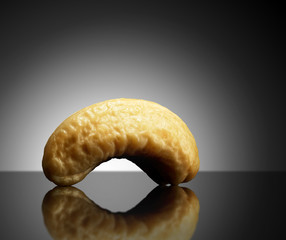 Cashew on black background with reflection. Close-up or macro. Health concept