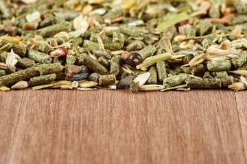 Mixed fodder for rodents on mahogany boards.