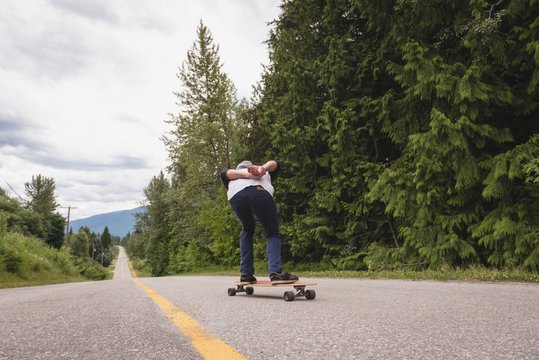 Man skateboarding on the road