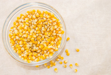 Corn for popcorn in a bowl on a white background