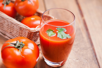 Glass of fresh tomato juice and tomatoes 