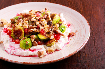 Brussels with cottage cheese, pomegranate and nut salad