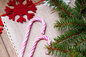 Candy canes, fir tree branch and handmade snow flakes 