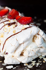 Pavlova - meringue cake with fresh strawberries. meringue roulade with creamstrawberries and raspberries