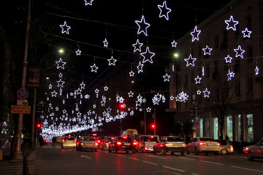 Christmas lights on Petre Melikishvili street in 
 Tbilisi, Georgia. Winter and holiday illumination in the form of stars. New Year's decor
