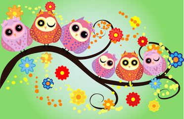 Bright cute cartoon owls sit on the flowering branches of fantastic trees