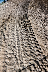 Track of truck wheels on sand 