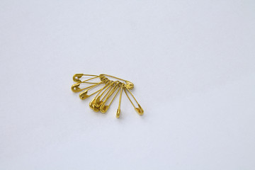 gold pins on a white background
