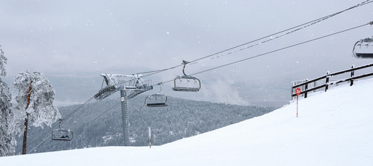 mountains with modern ski lift chair.