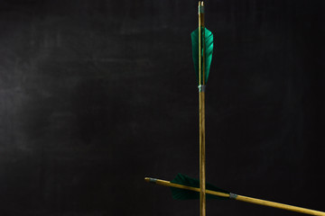 Old wood arrow. Beautiful dark background. Medieval weapons are handmade.