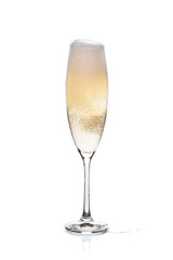 Glass of champagne with foam and bubbles on white