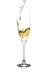 Champagne splash into the glass on white