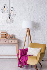 Fototapeta na wymiar modern room concept with brcik wall desk chair and pink blanket
