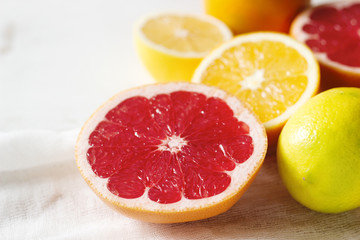 Citrus fruits grapefruit, oranges and lemon on a light background.