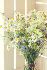 Beautiful spring bouquet with camomile in white rustic box, close up