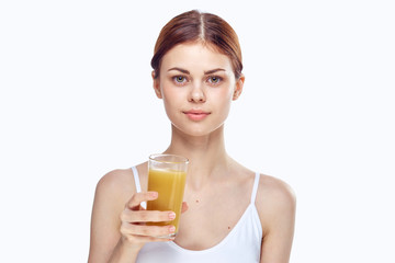1991946 Young beautiful woman on white isolated background holds a glass of freshly squeezed juice, diet, fitness, slimming
