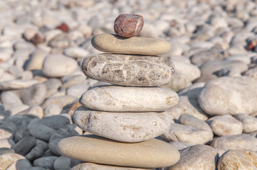 Fototapeta na wymiar Several pebble stone on beach complex like symbol for zen and relax concept