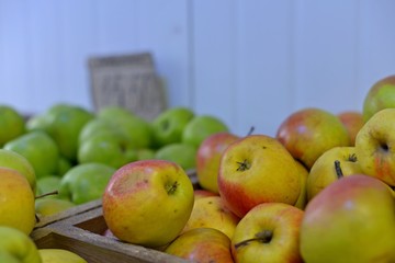 Tasty fresh red apples at grocery store.Buy & eat natural vitamin food.Farmer market department in food shop.Box of fruits on sale in fridge.Ripe red apples & oranges at food aisle in food department