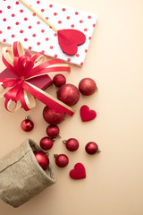 red gloss decoration ball with gift and ribbon bow on background