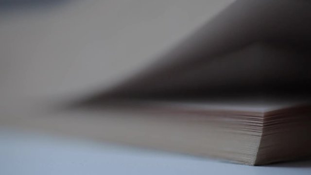Turning pages of old book, close-up