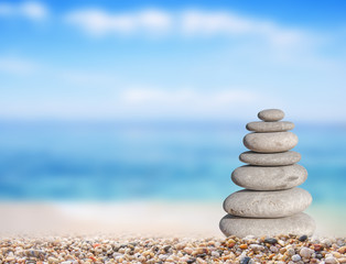 Fototapeta na wymiar Small beach stone from large to small on beach like symbol of balance