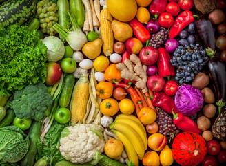 Fruits and vegetables background large Fruits and vegetables background rainbow large overhead colorful mix green to red in studio. Green, white, orange, red. - Powered by Adobe