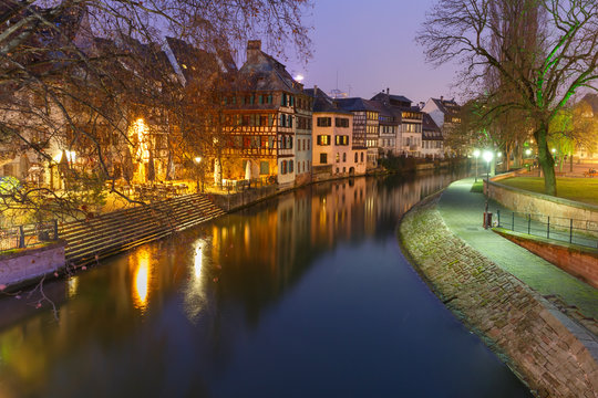 Traditional Alsatian half-timbered houses and canal in Petite France during twilight blue hour, Strasbourg, Alsace, France
