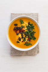 Bowl of butternut squash soup on napkin