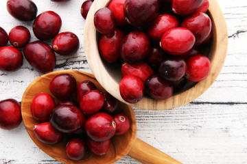 Harvest fresh red cranberries in wooden basket. Autumn concept.