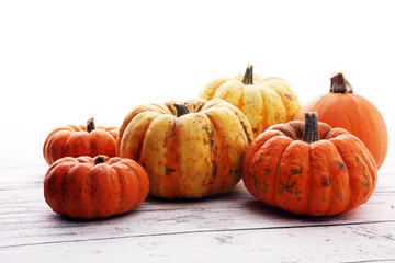 Many orange pumpkins on wooden background, Halloween concept.