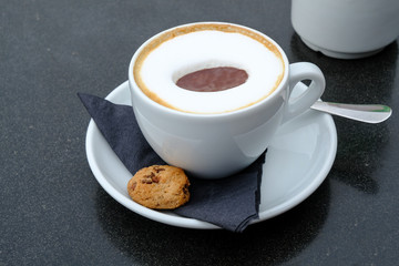 Cup of cappucino coffee in a white cup