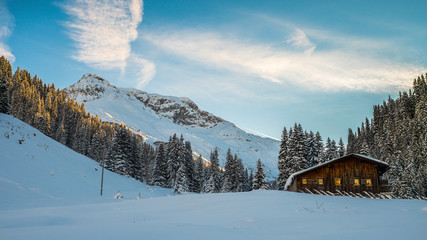  Wooden hut in the european alps during winter