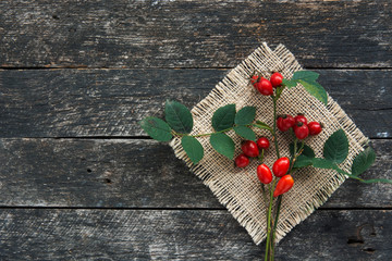 Medicinal plants and herbs composition Pile of Dog rose bunch branch Rosa canina on wooden table 